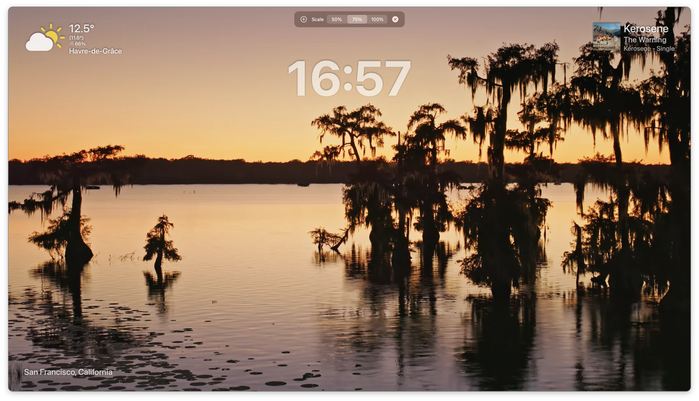 Aerial screensaver showing weather, clock, and now-playing overlays atop a sunset video