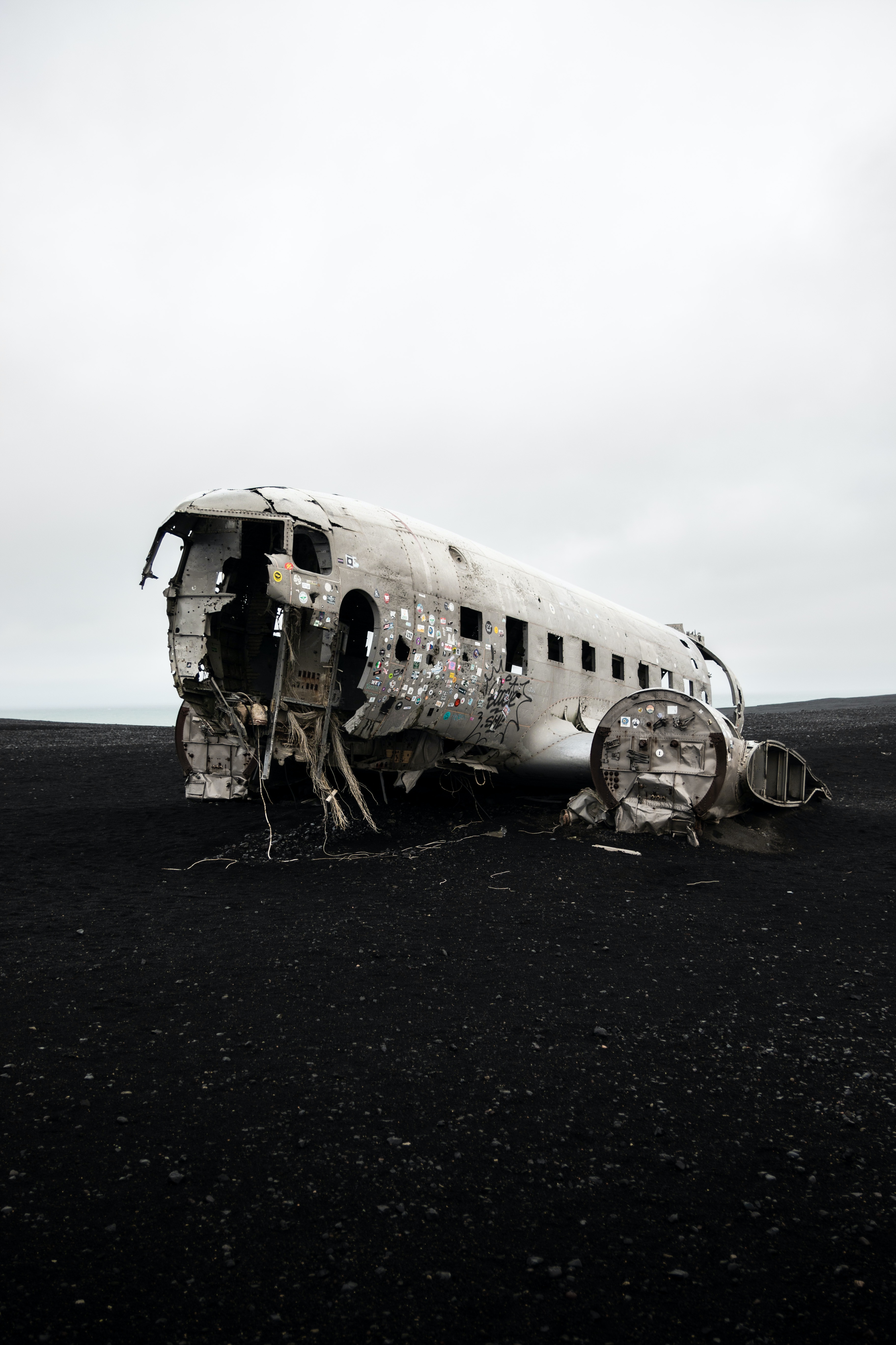 an_airplane_that_has_been_crashed_on_a_black_sand_beach