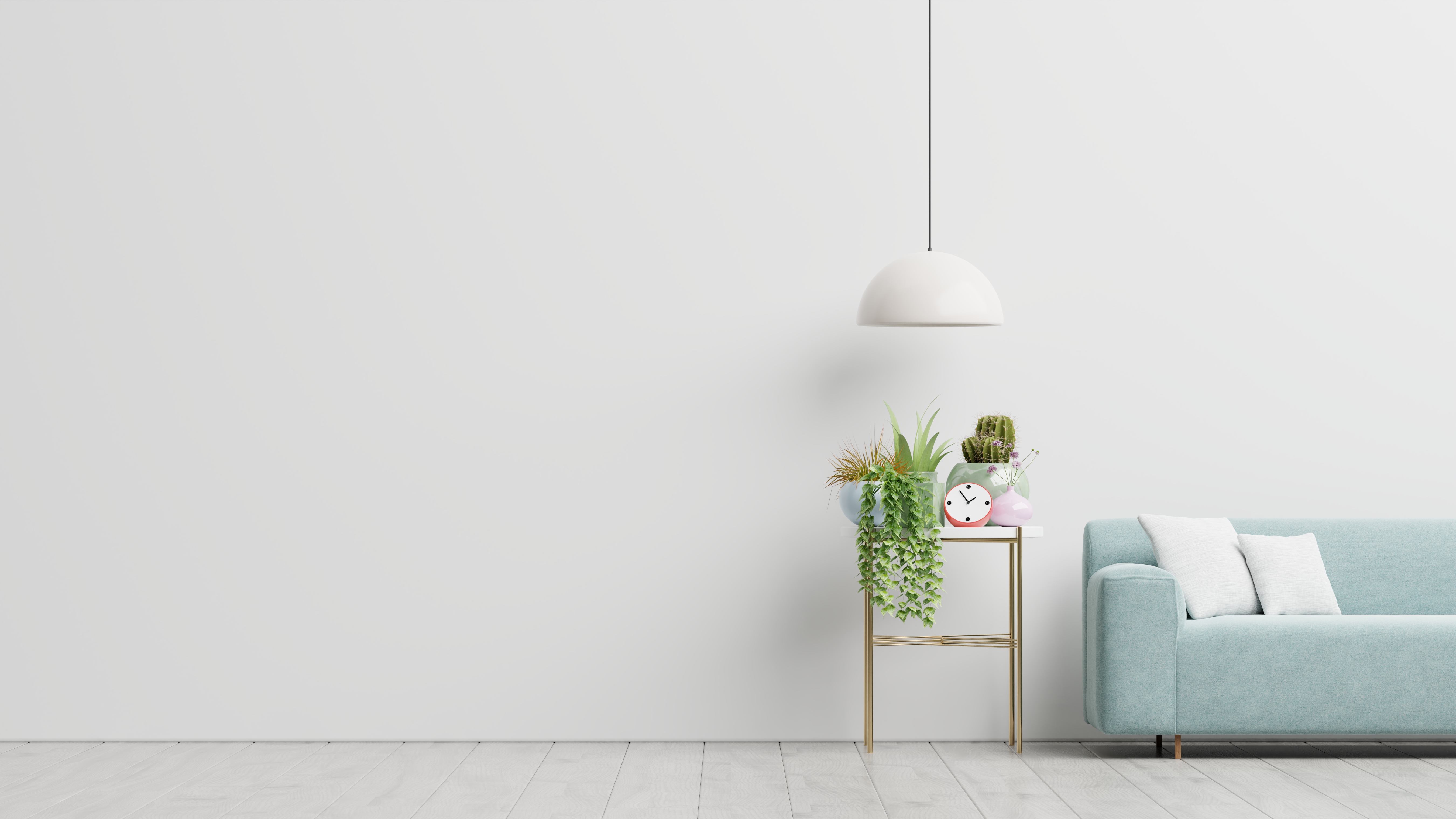 a_white_wall_with_a_blue_couch_and_a_lamp
