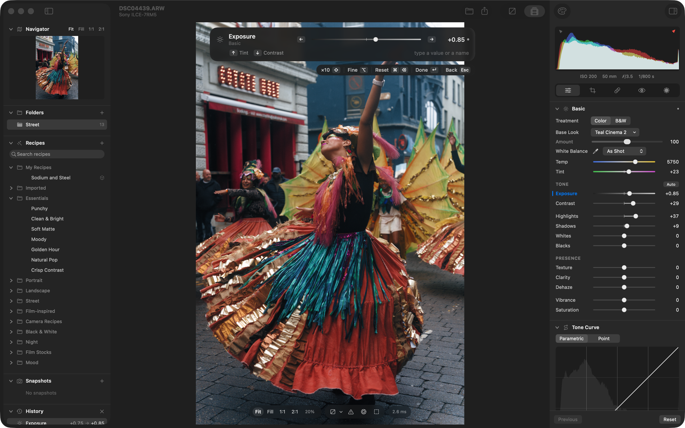 The slider bar for Exposure at +0.85 over the photo, with Tint and Contrast beside it and its keys in a hint bar