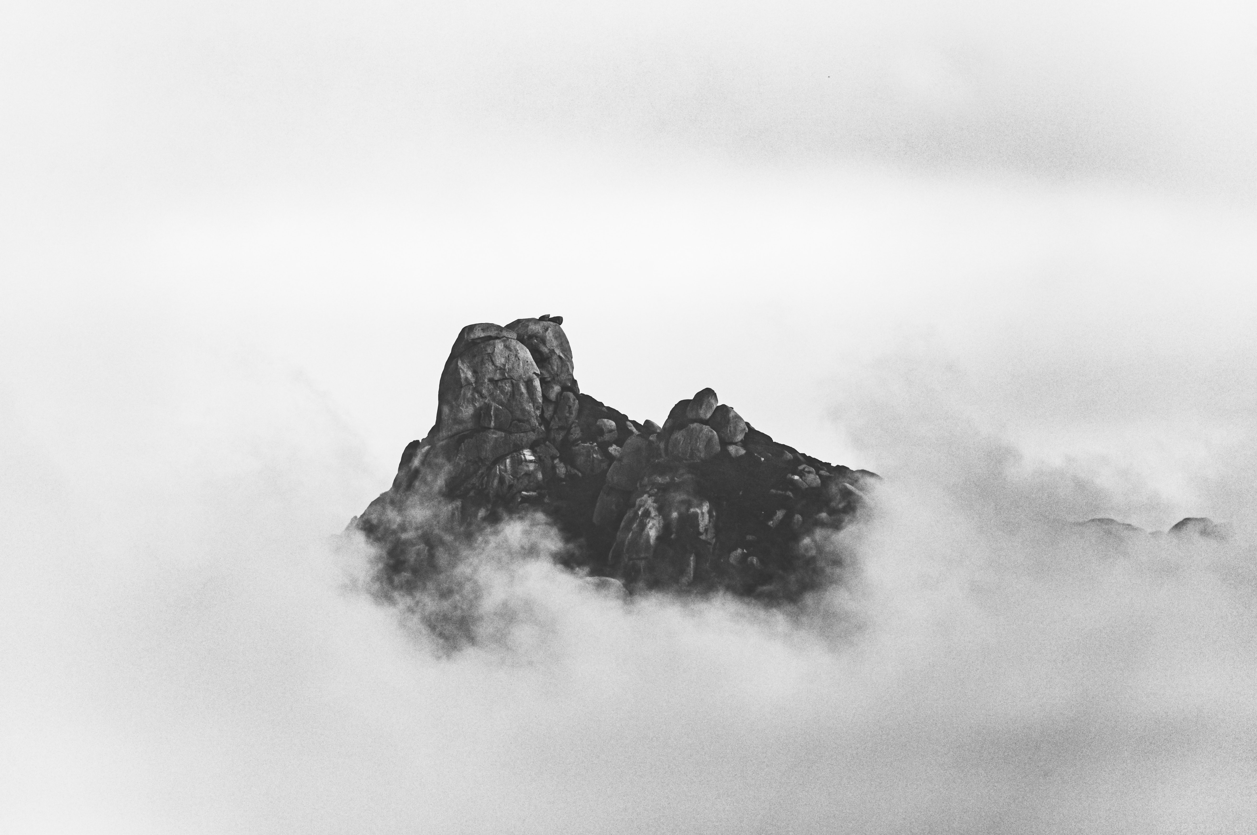 a mountain with clouds in the sky