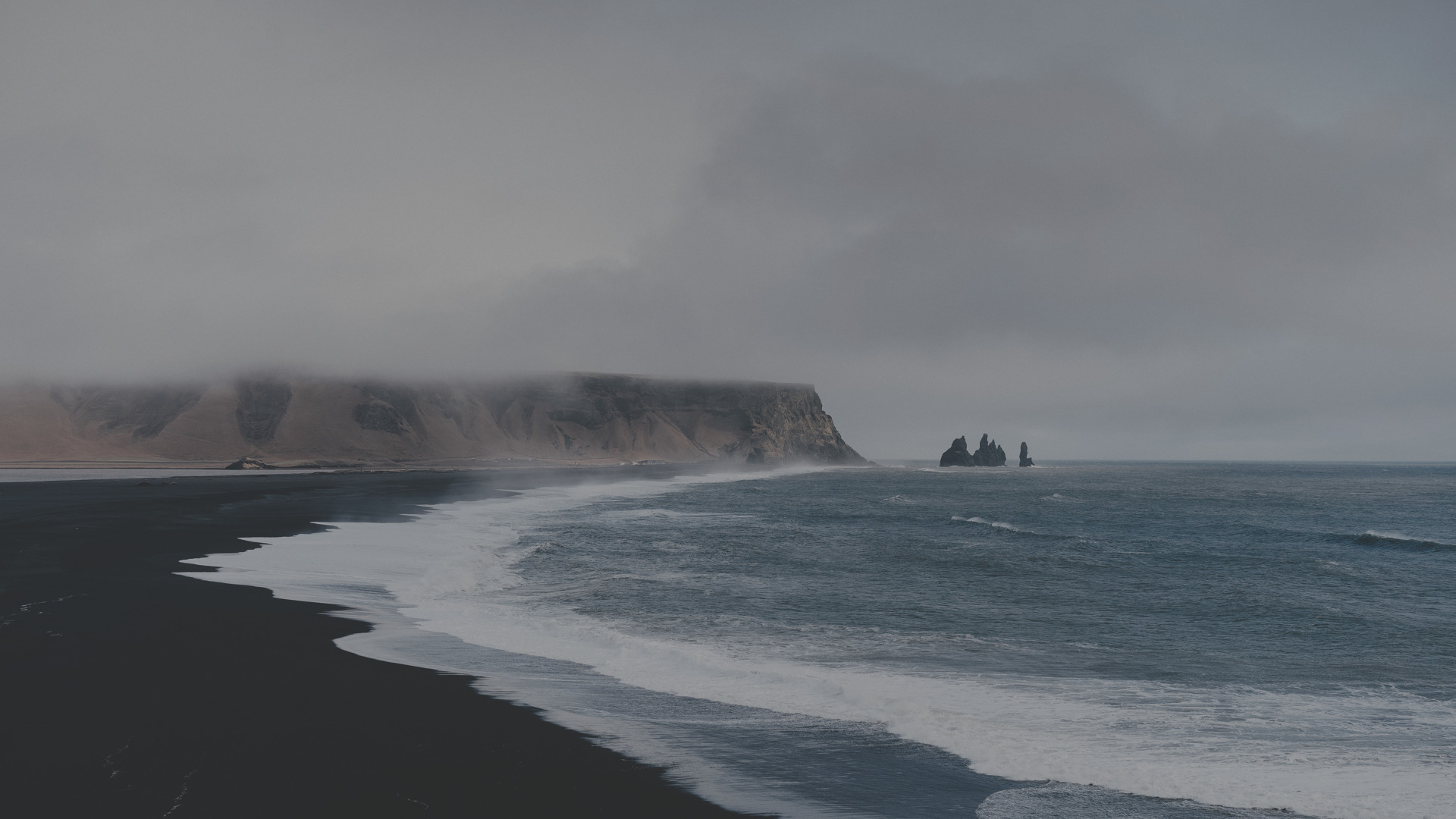 a beach with waves and rocks