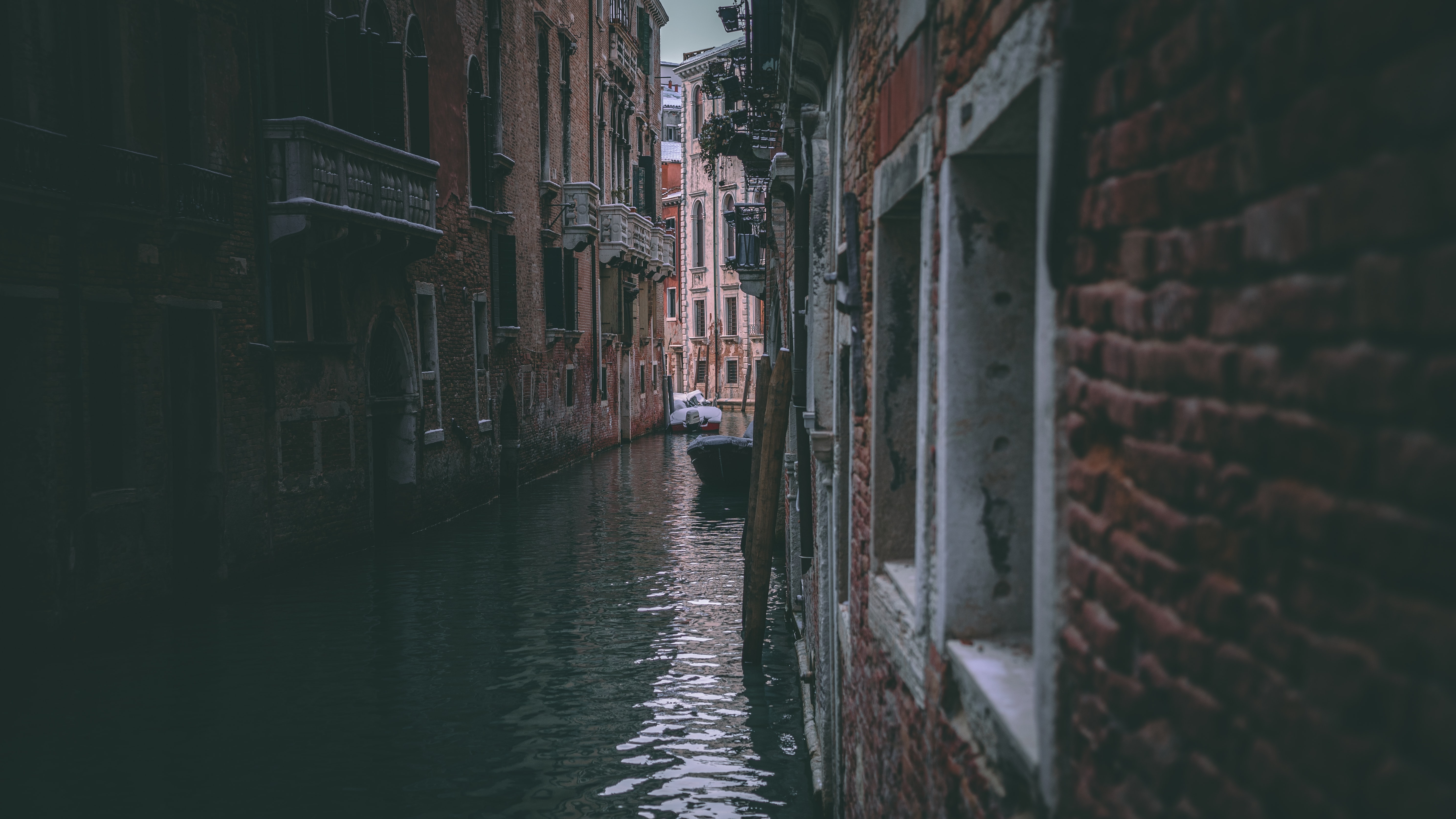 a canal between buildings with boats