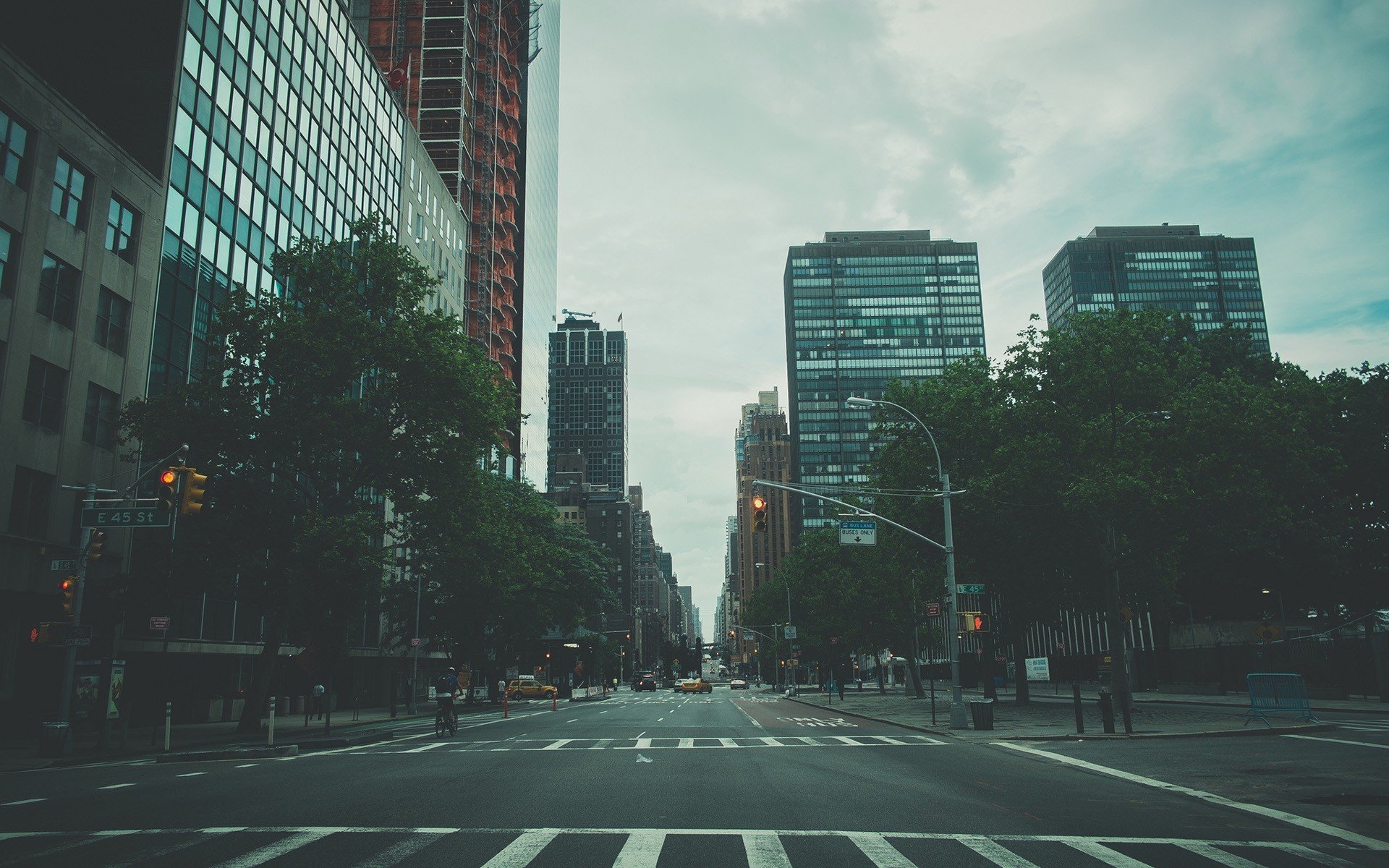 a street with trees and buildings in the background